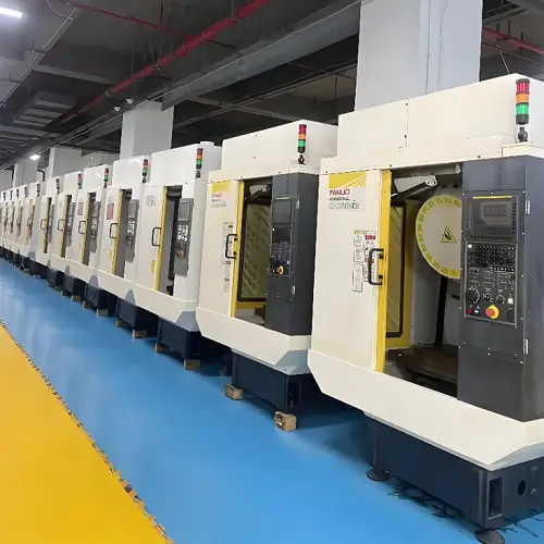 5-axis CNC milling machine machining a complex metal part, with simultaneous multi-axis motion used to maintain feature alignment and surface continuity in complex geometries 