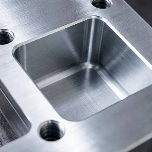 Machined aluminum pocket showing sharp internal corners with visible internal corner radius